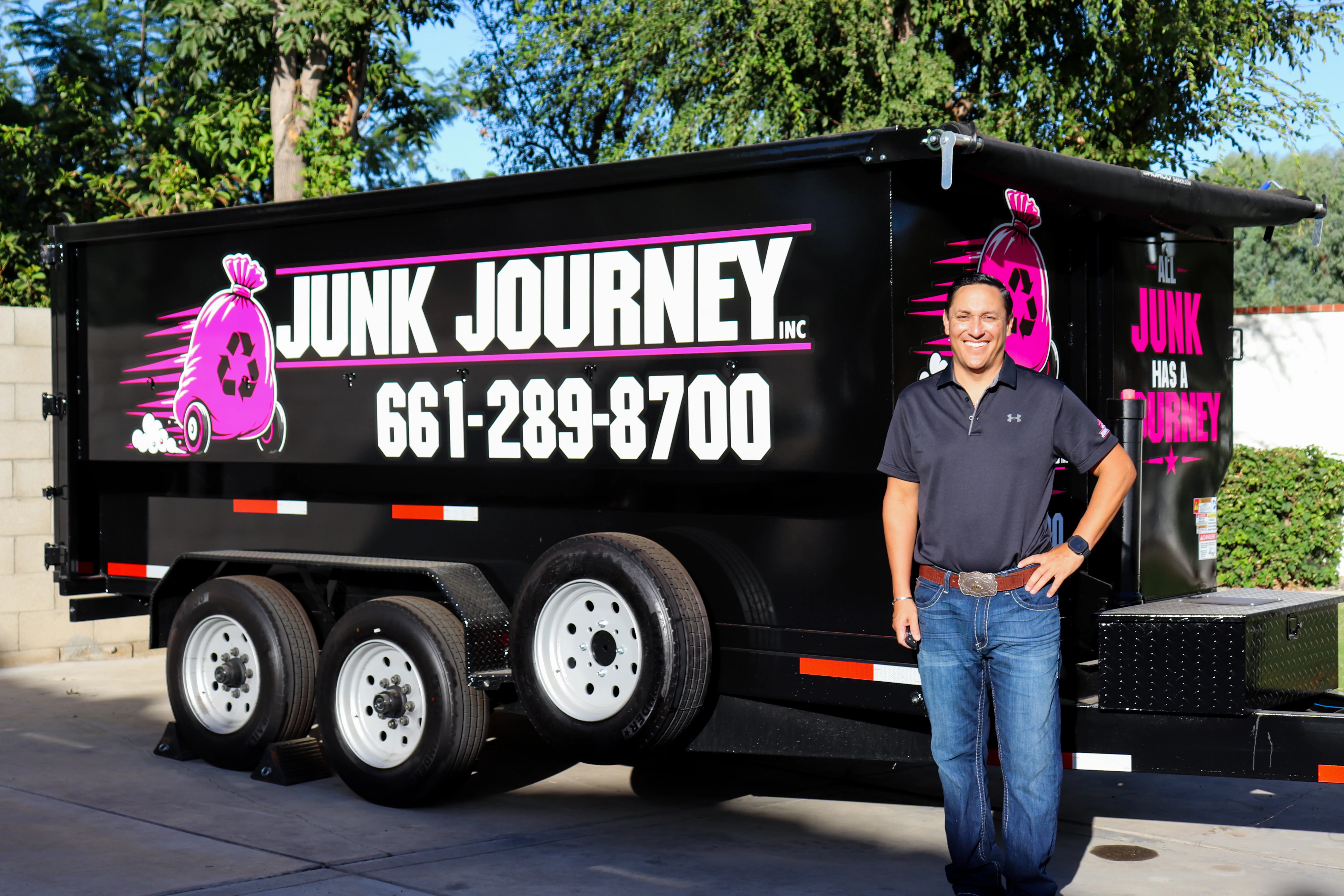 Junk Journey owner standing beside the company removal trailer